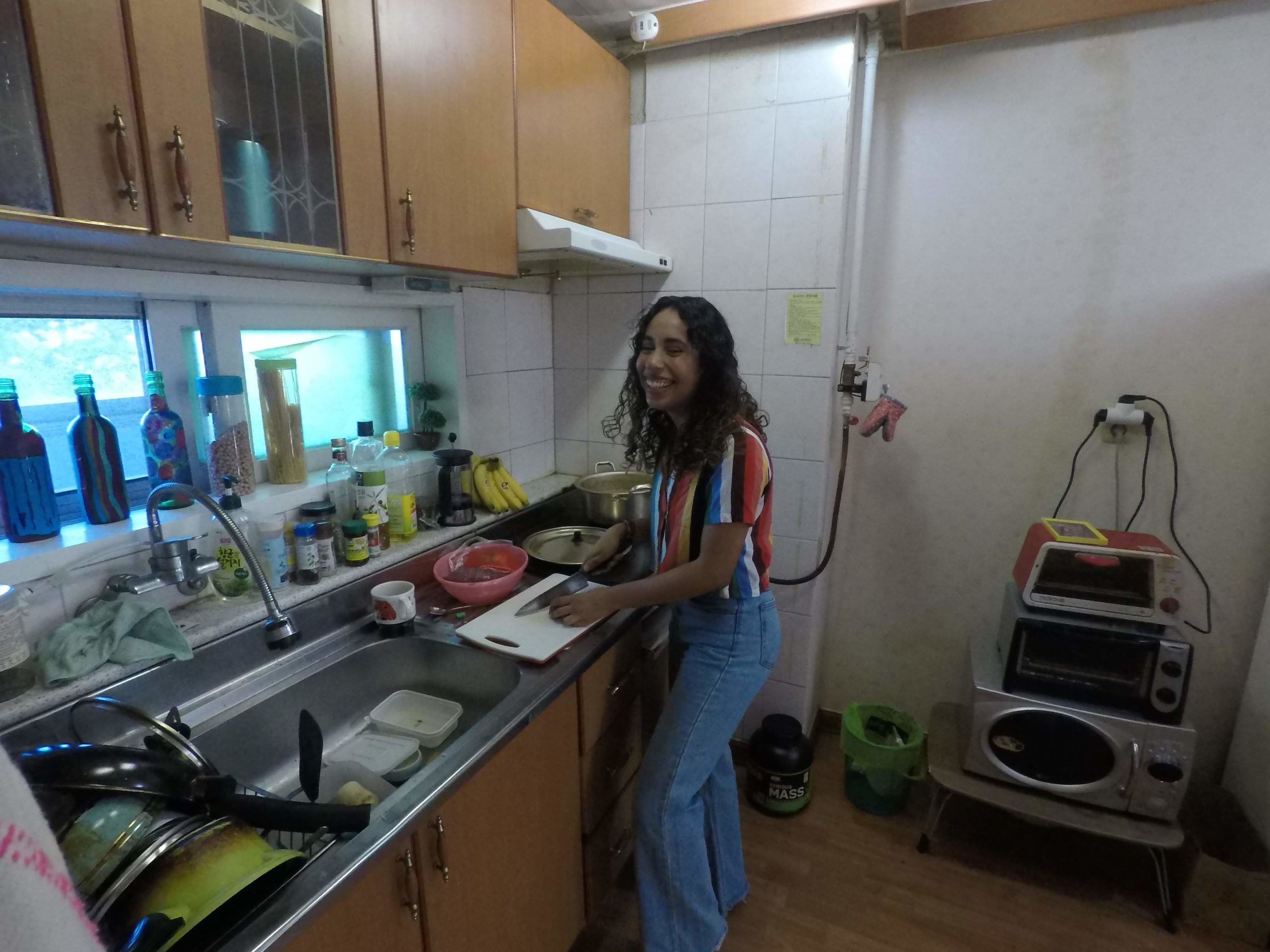 Natalie pictured at the center of the image in her first apartment in Imsil, South Korea.